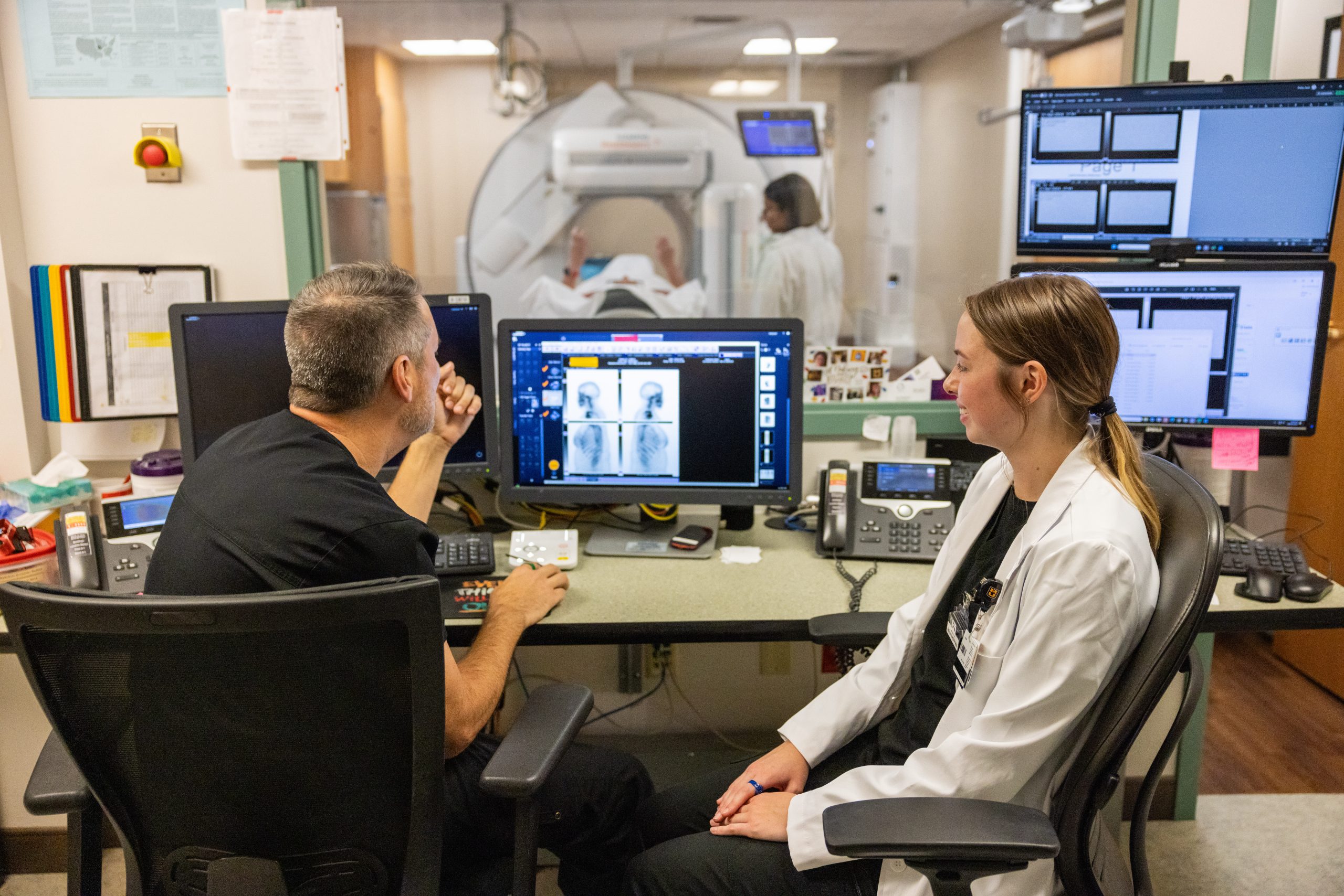 Two health care professionals reviewing patient imaging.