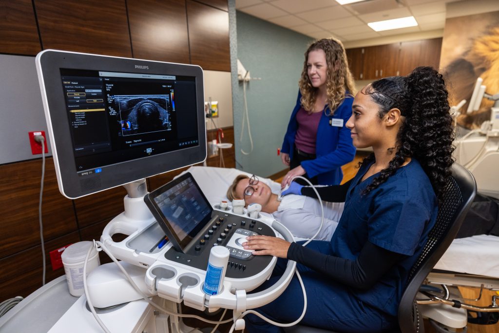 A doctor and ultrasound technician perform and ultrasound on a patient.